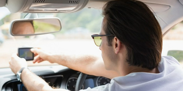 Man distracted by GPS while driving