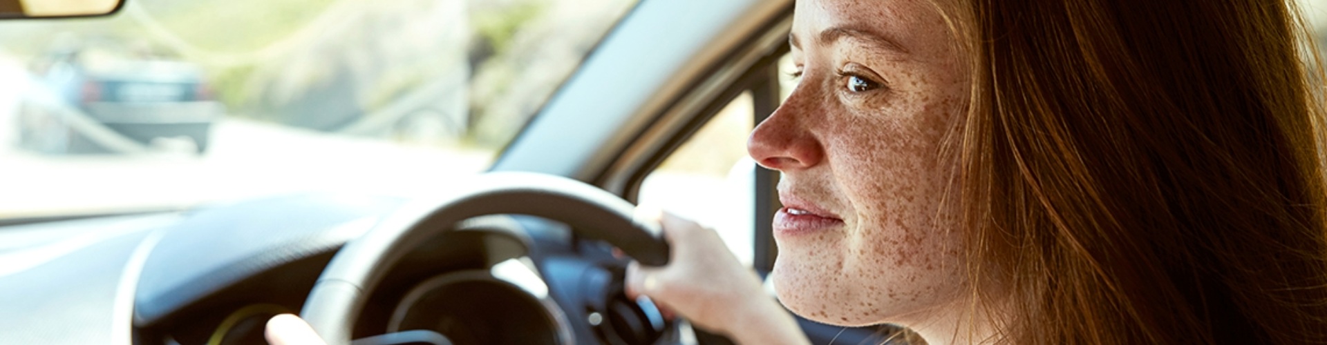 A young person driving a car
