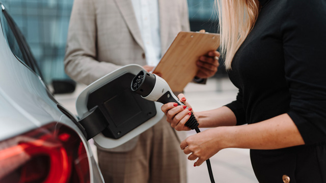 Person charging an electric car