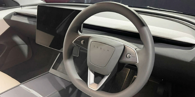 A view of the front dashboard and steering wheel in the 2024 Tesla Model 3. 