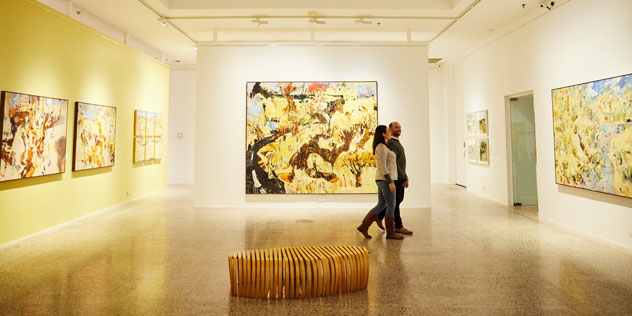 A couple walks through a gallery