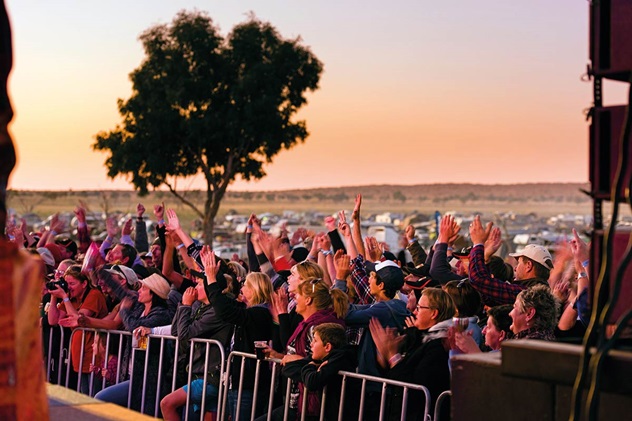 A crowd of people listen to music at the Big Red Bash near Birdsville Queensland