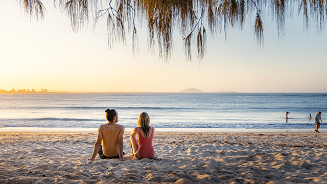A couple sitting on Bokarina Beach, Queensland