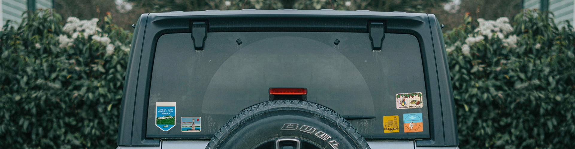 Rear windscreen of car with travel stickers