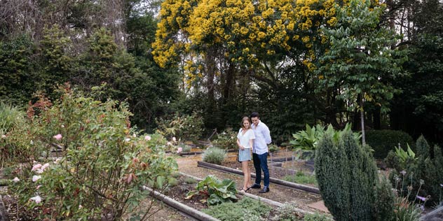 Couple enjoying a walk through The Fragrant Garden located within the grounds of Distillery Botanica, Erina