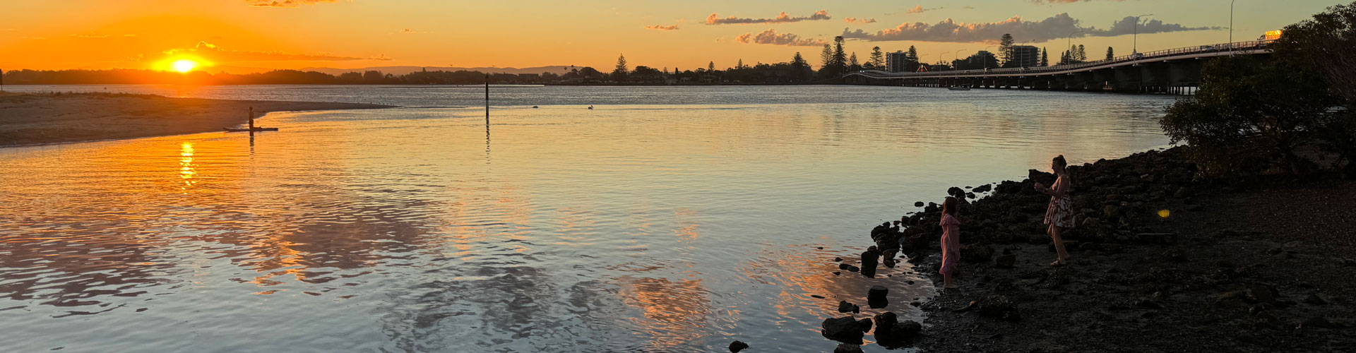 Forster at sunset with a view of the water