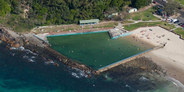 People enjoying Forster Ocean Baths on a sunny day, Forster.