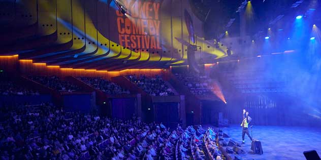 A comedian performs in front of a crowd at Sydney Comedy Festival