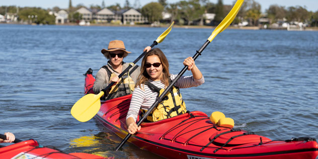 Two people in a red kayak on the Clarence River