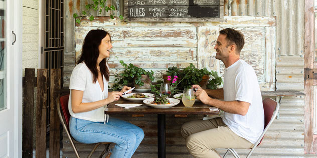A couple have a meal at Yum Yum Cafe Angourie