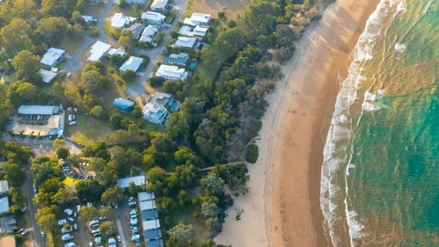 An ariel view of Murramarang resort nestled alongside a beautiful beach.