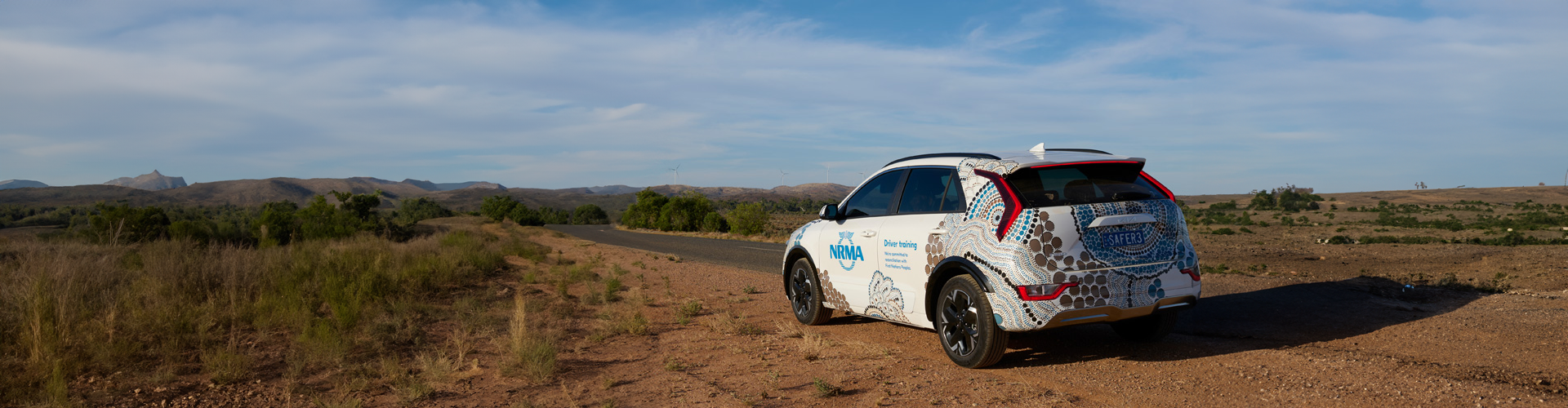 A car parked on a dirt road