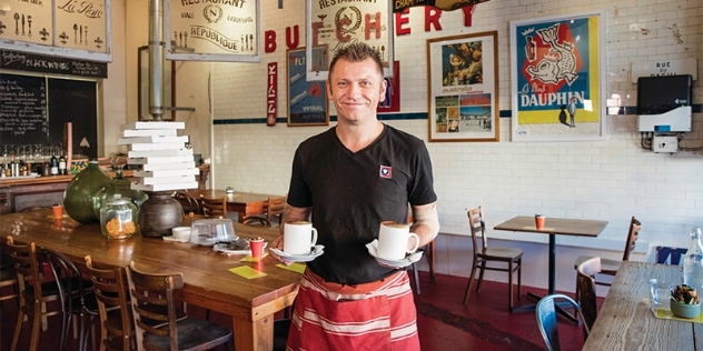 Waiter holds coffees at Butcher Shop Cafe Mudgee NSW