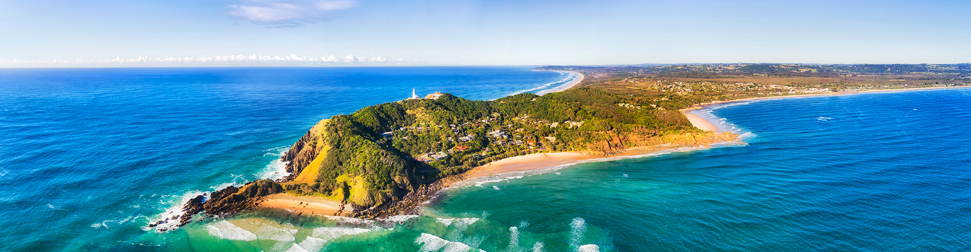 Byron bay and famous lighthouse on the top of headland facing Pacific ocean - the most eastern part of Australian continent.