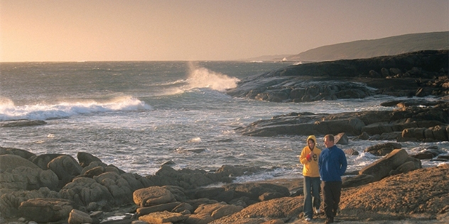 couple walk coastline at Cape Leeuwin