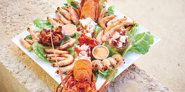 arial view of a lobster and prawn share platter on a large white square plate