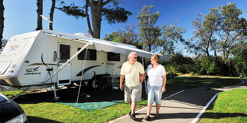 couple with caravan at NRMA eastern beach holiday park