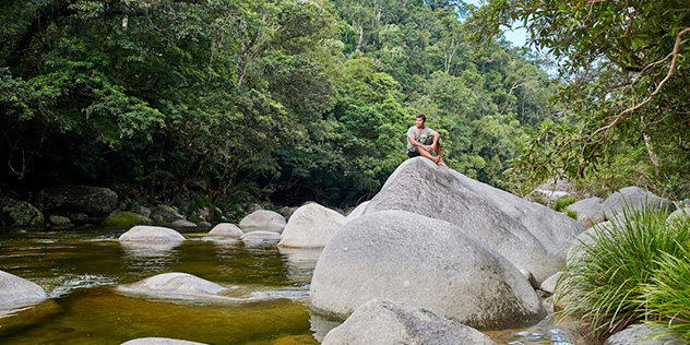 A view of a rocky river in Mossman Gorge with a guide from Walkabout Cultural Adventures, Queensland © Tourism Australia