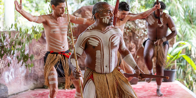 A group of Indigenous performers at Pamagirri Aboriginal Experience amid the rainforest in Queensland © Tourism Australia