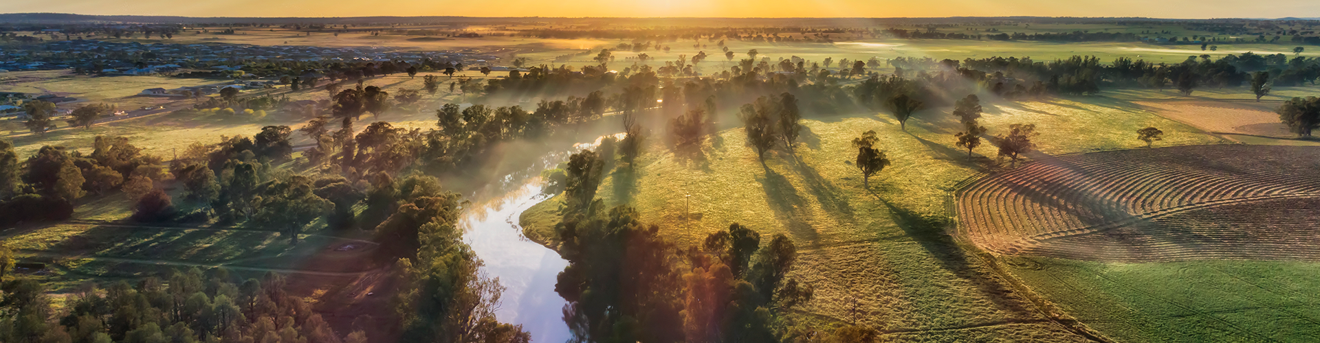Macquarie river in Dubbo near Dundullmal homestead and farm fields in aerial sunrise scenic view