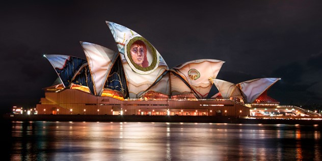  The Sydney Opera House at night, with patterns and a face projected over it's highest point.