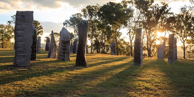 sun shines through the standing stones at Glen Innes