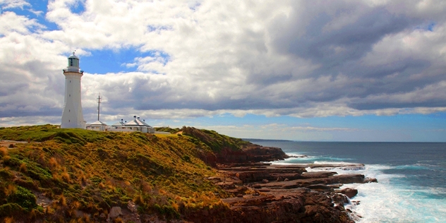 view of the Green Cape lighthouse with coastline and ocean to the right