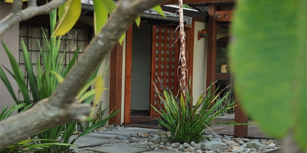 Balinese front door viewed through tropical landscaping