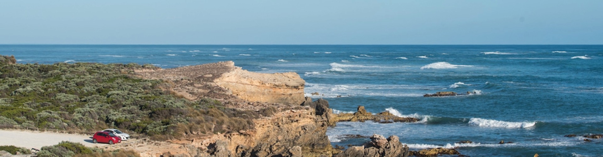 Limestone Coast SA Coastal lookout arial view of the coastline and ocean with a red and white car parked at the lookout