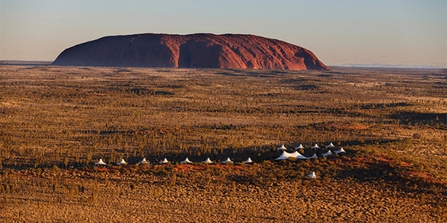 arial view of the white tent resort of Longitude 131 in the foreground of Ularu