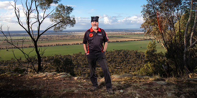 An indigenous man standing in the bush