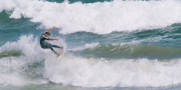 surfer riding a breaking wave