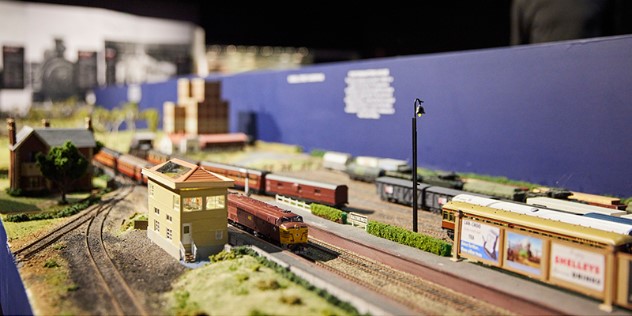  A close up of a model train on a landscaped track, as part of an exhibit in the Bathurst Rail Museum.