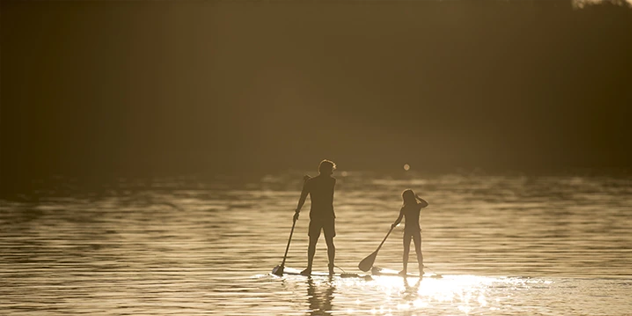 two people on a standup paddleboard