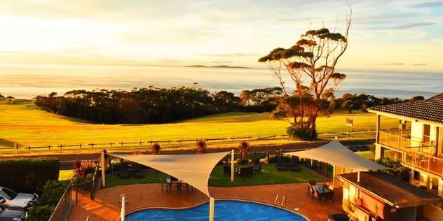 view of pool with ocean in the background