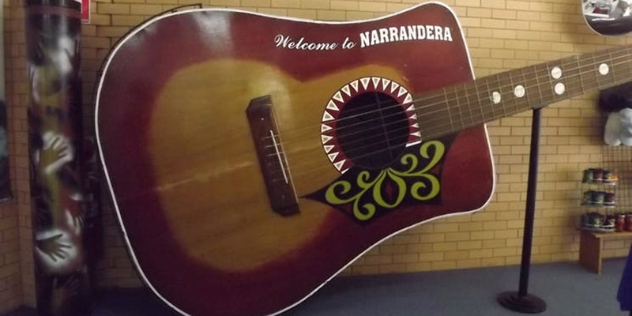 brown, 6 string, supersized guitar over two metres high