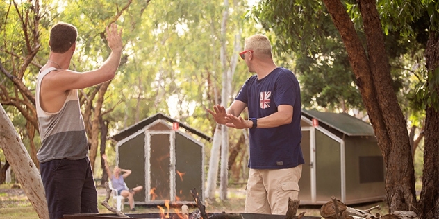 campers socialising around a campfire