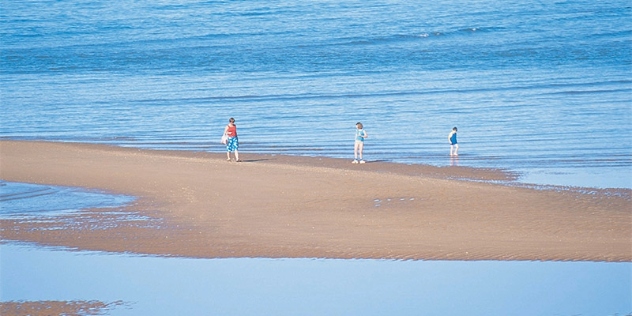 People walking on sandbar Port Hedland WA