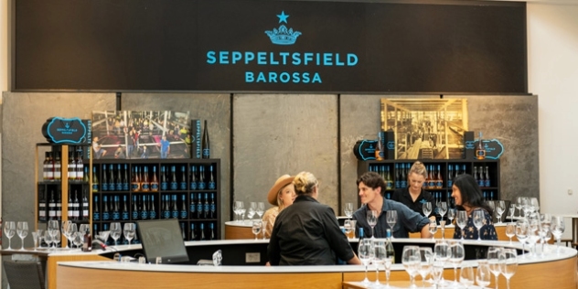 Seppeltsfield Barossa name and logo above a circular bar with people tasting wine