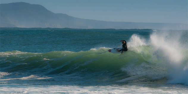 A surfer riding the crest of a wave. 