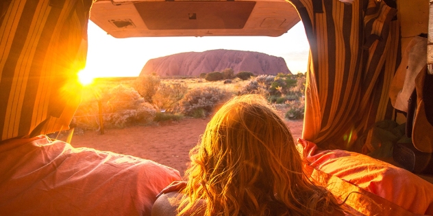 person looking at ularu from the back of a combi van