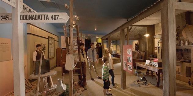 family walk through historical exhibition at Wadlata Outback Centre SA