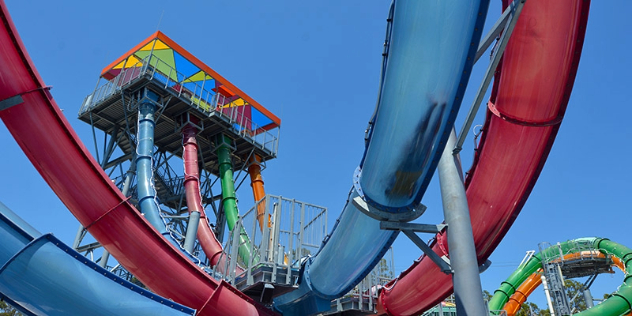 red and blue intertwining slides and slide platform viewed from below