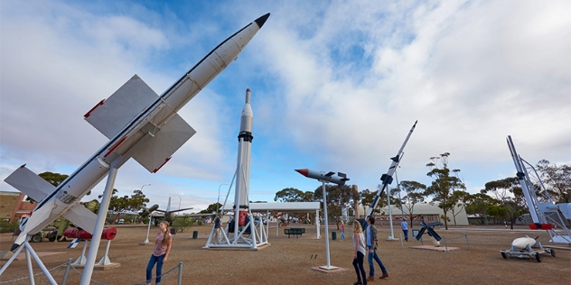 people looking at outdoor missile exhibit 