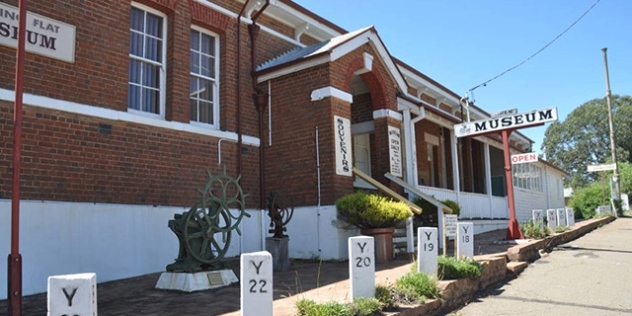 historic red and white brick building with museum sign