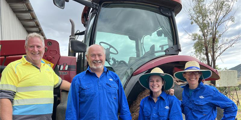 nrma volunteers smiling and standing in front of a red tractor