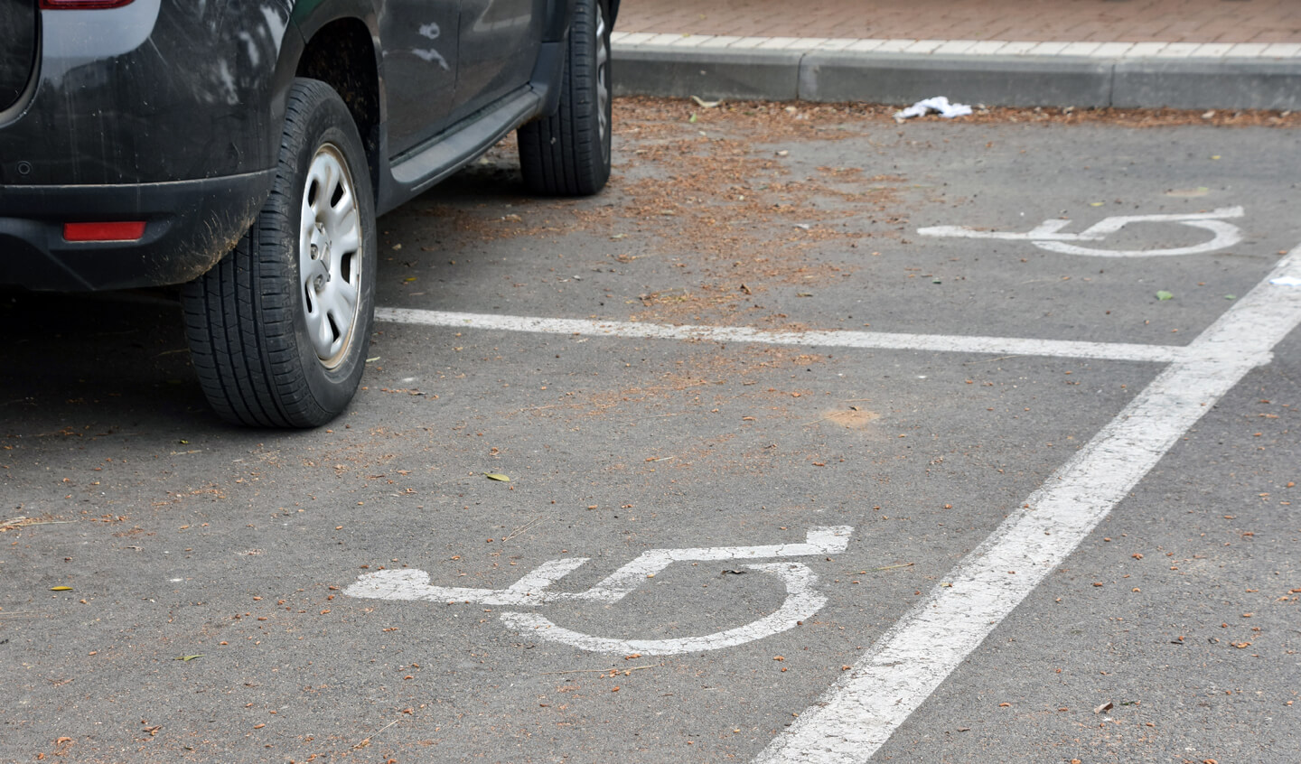 Car parked across two disabled parking spaces