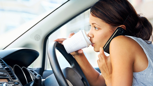 Woman driving while distracted