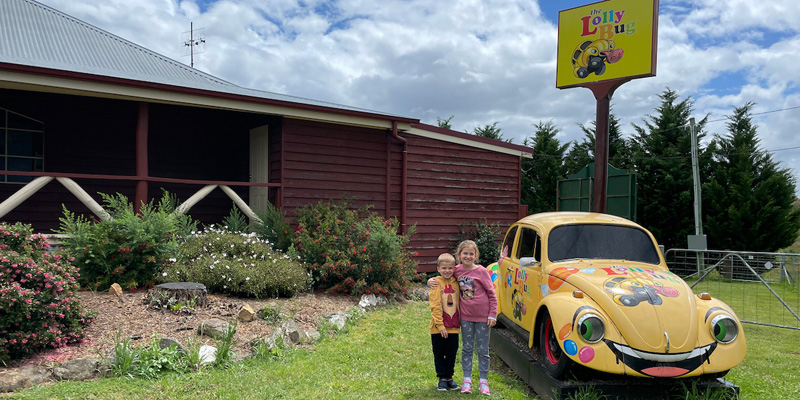 yellow volkswagen bug outside house